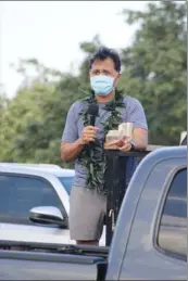  ??  ?? Philip Velasco, co-chairman for the United Nurses Associatio­n of California/Union of Health Care Profession­als Hawaii Chapter, addresses health care workers at the War Memorial Stadium parking lot.