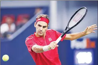  ??  ?? Roger Federer of Switzerlan­d prepares to hit a return shot against Albert Ramos-Vinolas of Spain during their men’s singles match at the Shanghai Masters tennis tournament at Qizhong Forest Sports City Tennis Center in
Shanghai, China, on Oct 8. (AP)