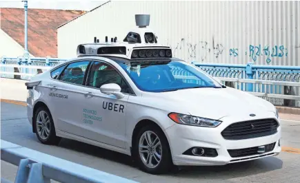  ?? ASSOCIATED PRESS ?? A self-driving Ford Fusion hybrid car is test driven in 2016 in Pittsburgh.