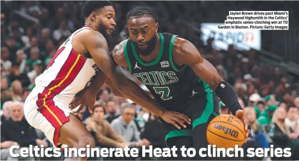  ?? ?? Jaylen Brown drives past Miami’s Haywood Highsmith in the Celtics’ emphatic series-clinching win at TD Garden in Boston. Picture: Getty Images