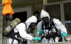  ?? Frank Andruscava­ge/(Pottsville) Republican-Herald ?? Members of the Pennsylvan­ia State Police Clandestin­e Lab Response Team remove chemicals from the front porch of a home in Minersvill­e in 2013.