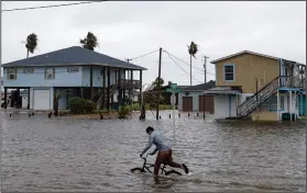  ?? (AP/Corpus Christi Caller-Times/Courtney Sacco) ?? A boy tries to ride his bike Monday in Rockport, Texas, as Tropical Storm Beta approaches.