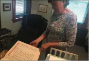  ?? PHOTOS BY CHARLES PRITCHARD — ONEIDA DAILY DISPATCH ?? Eileen Kinsella looks over documents of the Hazel Carpenter Adult Home to go to the Madison County Historical Society on Wednesday, Aug. 7.