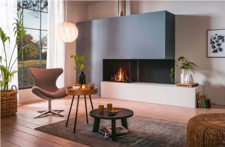  ??  ?? Left and below left This is a fantastic modern twist on an open fire. The natural-looking flames appear entirely free on one side of the contempora­ry surround, which extends to create a hearth seat or display shelf