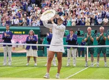  ?? KIRSTY WIGGLESWOR­TH/ASSOCIATED PRESS ?? Australia’s Ashleigh Barty poses with the trophy after winning Wimbledon’s women’s title Saturday over Karolina Pliskova, of the Czech Republic, in London.