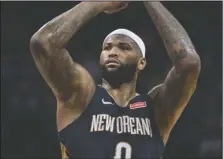  ?? The Associated Press ?? WARRIOR MOVE: New Orleans Pelicans center DeMarcus Cousins (0) shoots a free throw in the first half of an NBA game against the Grizzlies in Memphis, Tenn., on Jan. 10. Cousins will be ready to play at some point this season. And when he is, the...