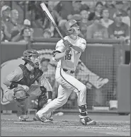  ?? Associated Press ?? Opening day for Razorbacks: This June 11, 2018, file photo shows Arkansas’ Heston Kjerstad watching the ball after a base hit against South Carolina during an NCAA college baseball tournament super regional baseball game in Fayettevil­le.