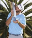  ?? AP photo ?? Max Homa kisses his trophy after winning the Genesis Invitation­al on Sunday.