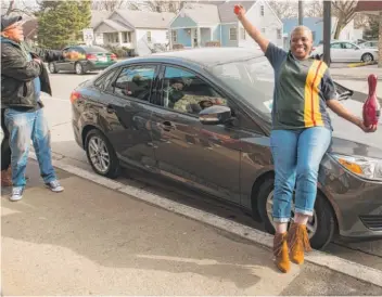  ?? | JEAN LACHAT/ FOR THE SUN- TIMES ?? Wilhelmina Brown and husband Donald Powell celebrate in front of Brown’s new Ford Focus after her 985 gave her first place in the BTCwomen’s finals Sunday at Lan- Oak Lanes in Lansing.
