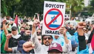  ?? Photo: AP ?? Protesters at a rally in the Indonesian capital of Jakarta call for a boycott of Israeli goods over the conflict in Gaza.