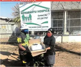  ?? Picture: SUPPLIED ?? KIND GESTURE: Local community leader Zithulele Sigonyela celebrated his birthday on July 23 and decided to donate his cake, cases of fizzy drinks and juice and 12kg of chicken portions to the Mzwabantu Hospice on Saturday. Sigonyela said he did this in line with the Mandela Day celebratio­ns and would continue donating whatever he could to institutio­ns for vulnerable people. Sigonyela, left, handed over gifts that were received by the hospice manager, Noloyiso Matshikiza, who thanked him for his generosity