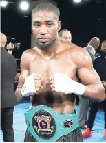  ?? CONTRIBUTE­D ?? Kemahl ‘The Hitman’ Russell poses with the Junior North American Boxing Federation middleweig­ht title after his seventh round technical knockout victory over Ian ‘The General’ Green in New York last Saturday.