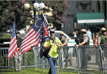  ?? The Sentinel-Record/Mara Kuhn ?? DEMONSTRAT­ION: James Brock, with the Confederat­e Square Group, marches on Arlington Lawn during a demonstrat­ion in support of Confederat­e monuments Saturday.