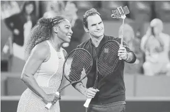  ?? PAUL KANE GETTY IMAGES ?? Serena Williams and Roger Federer take a selfie on court following their mixed doubles match at the 2019 Hopman Cup at RAC Arena Jan. 1 in Perth, Australia.