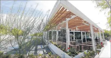  ?? Barbara Davidson Los Angeles Times ?? SHAKE SHACK will open its f irst West Coast restaurant in West Hollywood on Tuesday. The company hired an architect from Austin, Texas, to design the eatery, which fronts busy Santa Monica Boulevard.