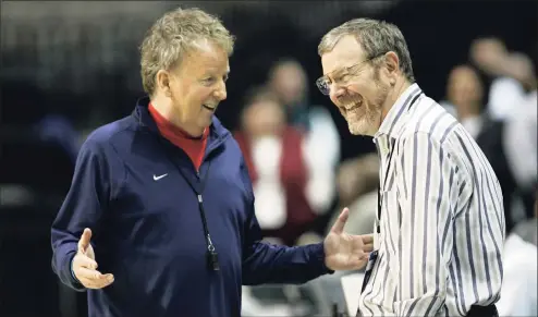  ?? Don Ryan / Associated Press ?? Houston coach Tom Penders, left, and television announcer and former coach P.J. Carlesimo, right, smile during NCAA basketball practice in Spokane, Wash., in 2010.