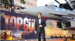 ?? AP PHOTO/ALBERTO PEZZALI ?? Tom Cruise poses for the media during the ‘Top Gun Maverick’ UK premiere in May at a central London cinema.