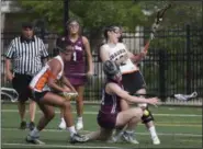  ?? JEN FORBUS — THE MORNING JOURNAL ?? Chagrin Falls’ Maddie Miralia, right, and Rocky River’s Lauren Cain collide during a Division II state semifinal May 30 at Oberlin.