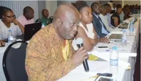  ??  ?? Mr Jacob Nyathi (with mic) a delegate, makes a contributi­on during the Ministry of Macro-Economic Planning and Investment promotion workshop at a local hotel yesterday