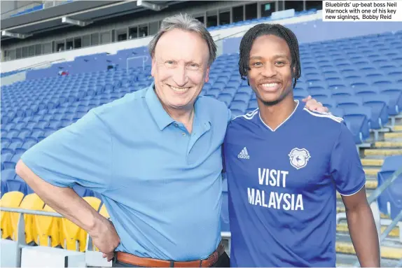  ??  ?? Bluebirds’ up-beat boss Neil Warnock with one of his key new signings, Bobby Reid