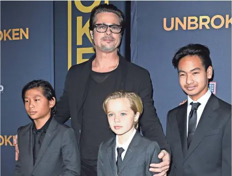  ??  ?? Brad Pitt with Pax, Shiloh and Maddox in December 2014. Angelina Jolie is seeking sole physical custody of their six kids. ROBYN BECK, AFP/GETTY IMAGES