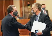  ?? Eric Gay / Associated Press ?? Bill Magness, president and CEO of the Electric Reliabilit­y Council of Texas, right, arrives to testify in Austin on Thursday.