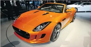  ?? PHOTOS: ANDREW MCCREDIE/ PNG ?? Arguably one of the most beautiful machines to be unveiled in L. A. was the all- new 2014 Jaguar F- Type, a rear- wheel drive two seater with an all- aluminum body and three engine choices.