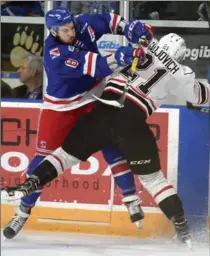  ?? DAVID BEBEE, RECORD STAFF FILE PHOTO ?? Kitchener Rangers defender Dylan Di Perna battles Owen Sound Attack forward Jonah Gadjovich along the boards in the first period of Game 3 of their playoff series in March.