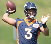  ?? AP Photo/David Zalubowski ?? ■ Denver Broncos quarterbac­k Russell Wilson takes part in drills April 27, at the NFL football team’s voluntary minicamp at the team’s headquarte­rs in Englewood, Colo.