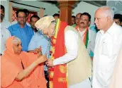  ?? — PTI ?? BJP national president Amit Shah visits the pontiff of Suttur Mutt, in Mysore on Friday.