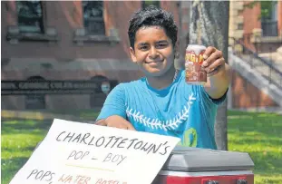  ?? DANIEL BROWN/THE GUARDIAN ?? Karthik Christo salutes his future customers at his location beside Richmond Street in Charlottet­own on July 31. The Charlottet­own Pop Boy is typically selling pop in front of the George Coles building on any sunny afternoon this summer.