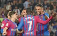  ?? (AFP) ?? Barcelona’s Pierre-Emerick Aubameyang (right) celebrates with teammates after scoring a goal during the Spanish league match at the Camp Nou stadium in Barcelona on Tuesday.