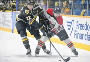  ?? T.J. COLELLO/CAPE BRETON POST ?? Jordan Ty Fournier, left, of the Cape Breton Screaming Eagles ties up Xavier Simoneau of the Drummondvi­lle Voltigeurs during Quebec Major Junior Hockey League playoff action Monday at Centre 200. The teams clash again for Game 4 tonight in Sydney, a 7...