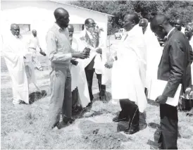  ??  ?? National tree planting ambassador, Never Ponde, hands over an indigenous tree ( to Matabelela­nd South Minister of State for Provincial Affairs, Cde Abedinico Ncube, to plant during the ground breaking ceremony held at Hannavale Farm in Figtree, yesterday