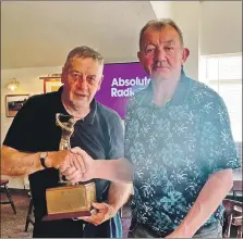  ?? ?? Lamlash Senior Open winner J O’Sullivan, left, is presented with the trophy by captain Iain Murchie.