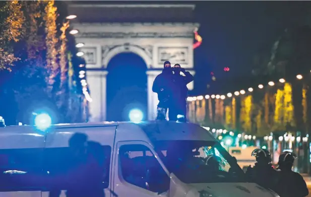  ??  ?? FATAL ATTACK: Officers secure the area after a gunman opened fire on Champs-Elysees in Paris, killing one police officer and wounding three other people. Picture: GETTY