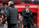  ?? GETTY IMAGES/ SHAUN BOTTERILL ?? Chelsea manager Antonio Conte has a worried look as Manchester United manager Jose Mourinho watches his team beat the .English Premier League leaders 2-0.