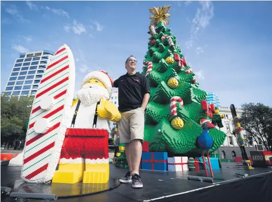  ?? Picture / Dean Purcell ?? Ryan McNaught with the Lego Christmas tree in Aotea Square. His team added a rugby ball, kiwi, pukeko ( below) and a sacred kingfisher to give it a more local look.