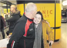  ?? PETER MORRISON ?? Martin Conway welcomes his daughter Emer home for Christmas at Belfast Internatio­nal Airport