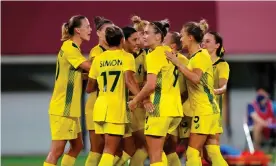  ?? Stadium. Photograph: Dave Shopland/REX/Shuttersto­ck ?? The Matildas celebrate Wednesday night’s 2-1 opening win over New Zealand at Tokyo