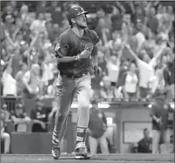  ?? AP/MORRY GASH ?? Chicago third baseman Kris Bryant watches the ball as he starts to round the bases while fans react to his two-run home run Thursday that gave the Cubs a 5-3 victory over the Milwaukee Brewers at Miller Park in Milwaukee.