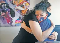  ?? GABRIELA CAMPOS/THE NEW MEXICAN ?? Marcos Tapia, a nearly 9-year-old from Española, hugs his mother, Vanessa Tapia, after receiving a new camper Wednesday through Make-A-Wish New Mexico.