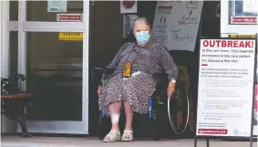  ?? DAVID BLOOM ?? A woman exits the front door of the Good Samaritan Society Southgate Care Centre in Edmonton, where five women died of COVID-19 Thursday, bringing the death toll to 21.