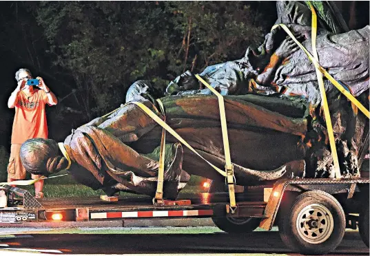  ??  ?? Confederat­e statues were removed from parks in Maryland, main picture, and Alabama, top right, in the early hours; above right, mourners gather for a memorial service in honour of victim Heather Heyer