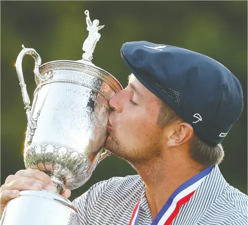  ?? Gregory Shamus / Gett y Imag es ?? Bryson Dechambeau kisses the championsh­ip trophy in celebratio­n after winning the U. S. Open
on Sunday at Winged Foot Golf Club in Mamaroneck, New York.