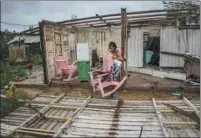  ?? RAMON ESPINOSA / AP ?? Maria Llonch retrieves her belongings from her home damaged by Hurricane Ian in Pinar del Rio, Cuba, on Tuesday. Disastrous hurricanes and typhoons have been seen more frequently in recent years as a result of climate change.