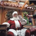  ?? BRIAN POWERS/USA TODAY NETWORK ?? Lillian Grimes of Des Moines cleans and sanitizes the plexiglass on the side of Santa’s “office” at Valley West Mall in West Des Moines, Iowa.