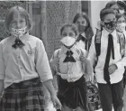  ?? LYNNE SLADKY/AP ?? Pediatrici­ans and educators are trying to keep kids in school and protect them from contagious diseases.