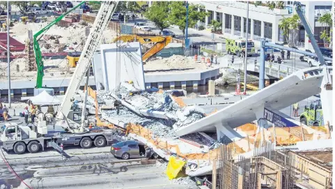  ??  ?? Personal de emergencia informó que al menos ocho vehículos habrían quedado atrapados bajo los escombros del puente que se desplomó ayer en Miami.