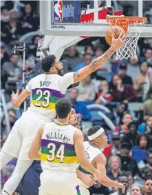  ?? Scott Threlkeld, The Associated Press ?? New Orleans Pelicans center Anthony Davis grabs a rebound Friday night against the Minnesota Timberwolv­es. Davis scored 32 points despite sitting out the fourth quarter.